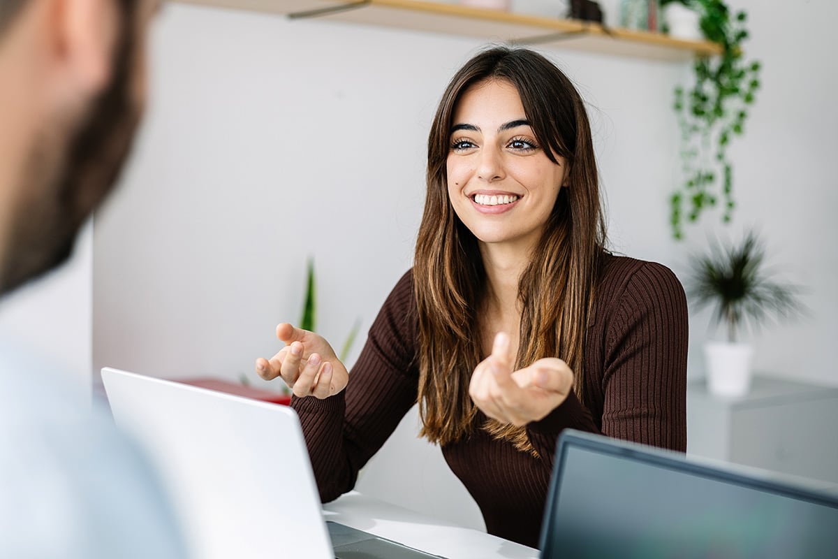 A tutor and a student talking together during a training session