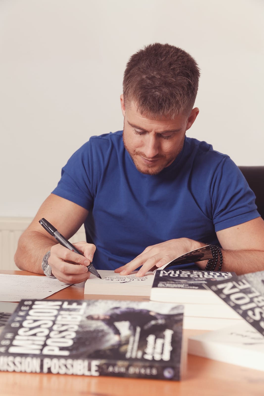 Ash Dykes signing copies of his book Mission Possible