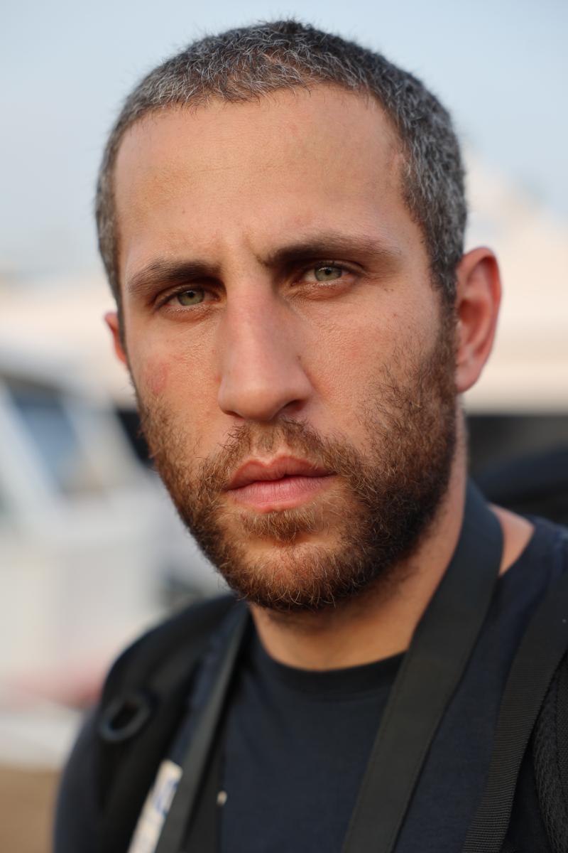 close-up outdoor portrait of a bearded man facing the camera