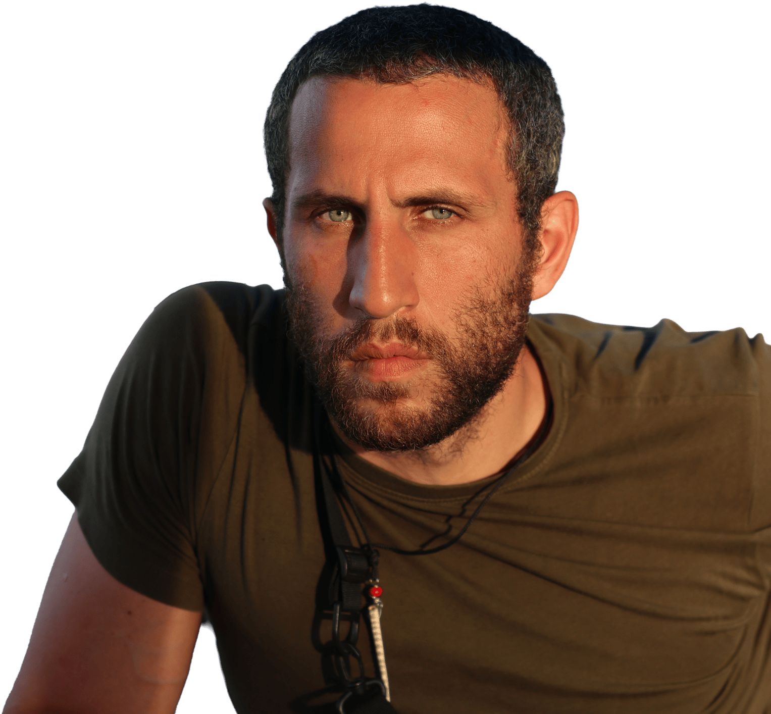 close-up portrait of a bearded man in an olive t-shirt against a white background